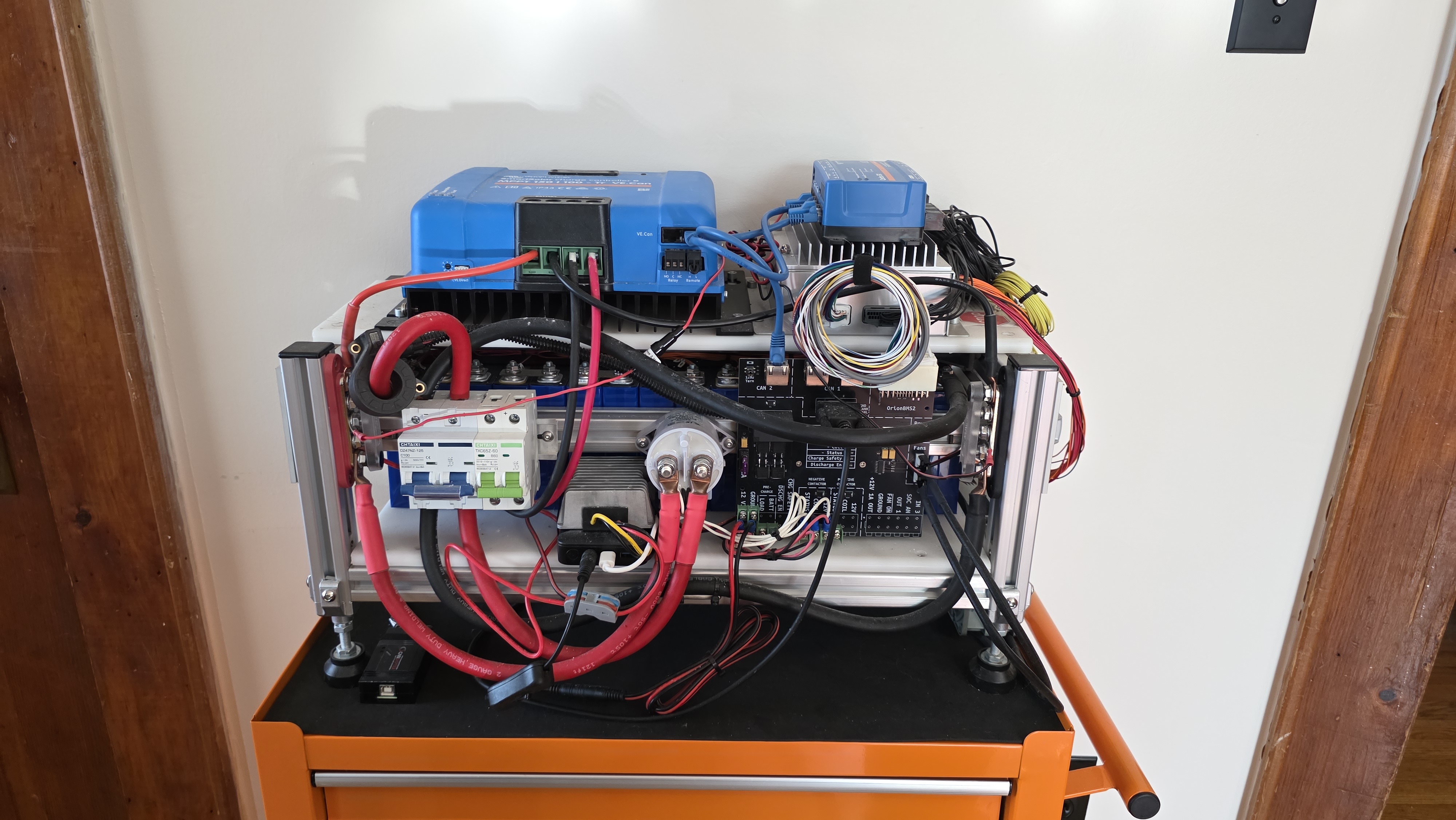 The completed test bench: a rectangular box frame made from aluminum extrusion, packed with wires and electrical devices.